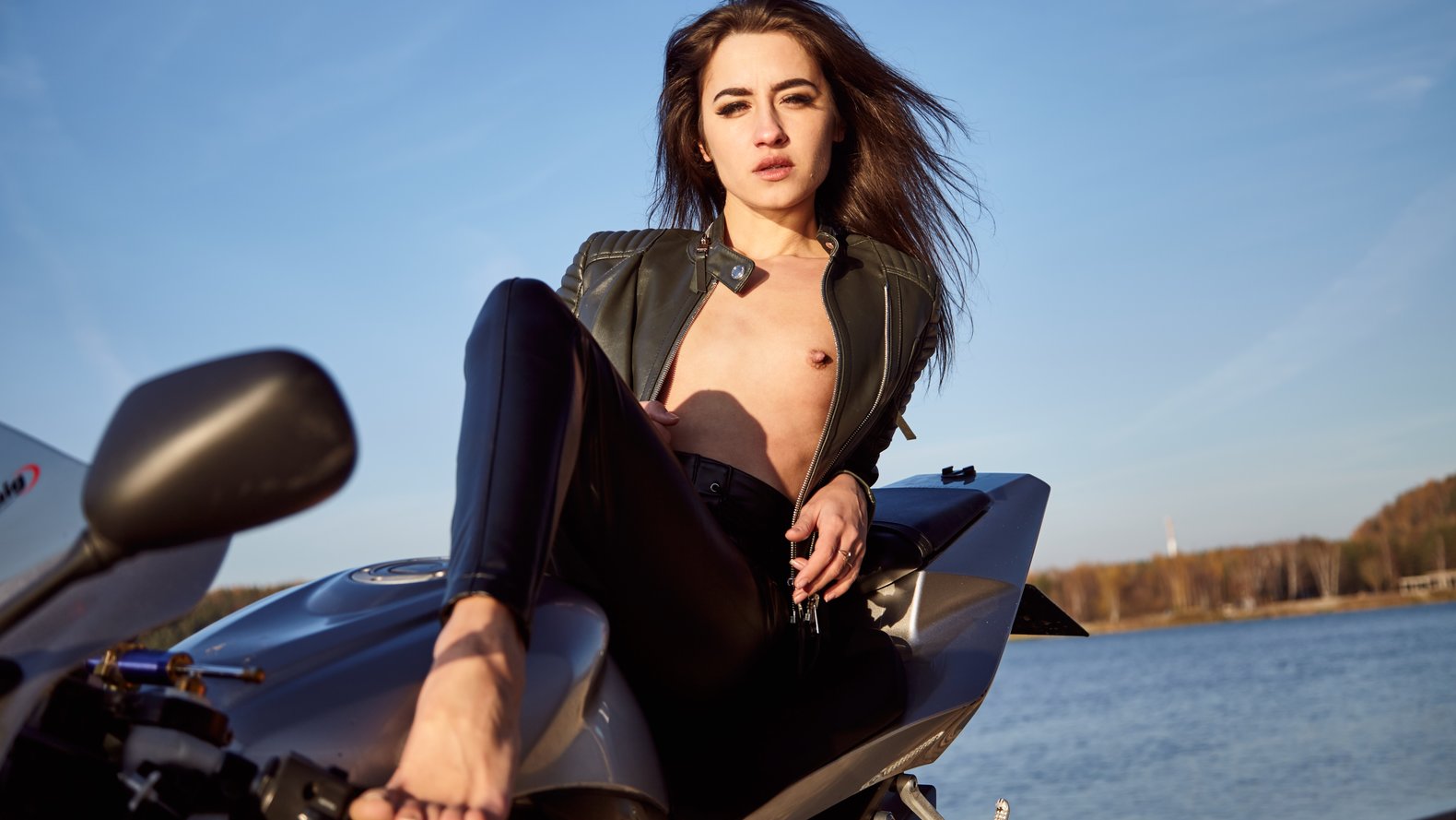 Young woman with small tits topless leather jacket under