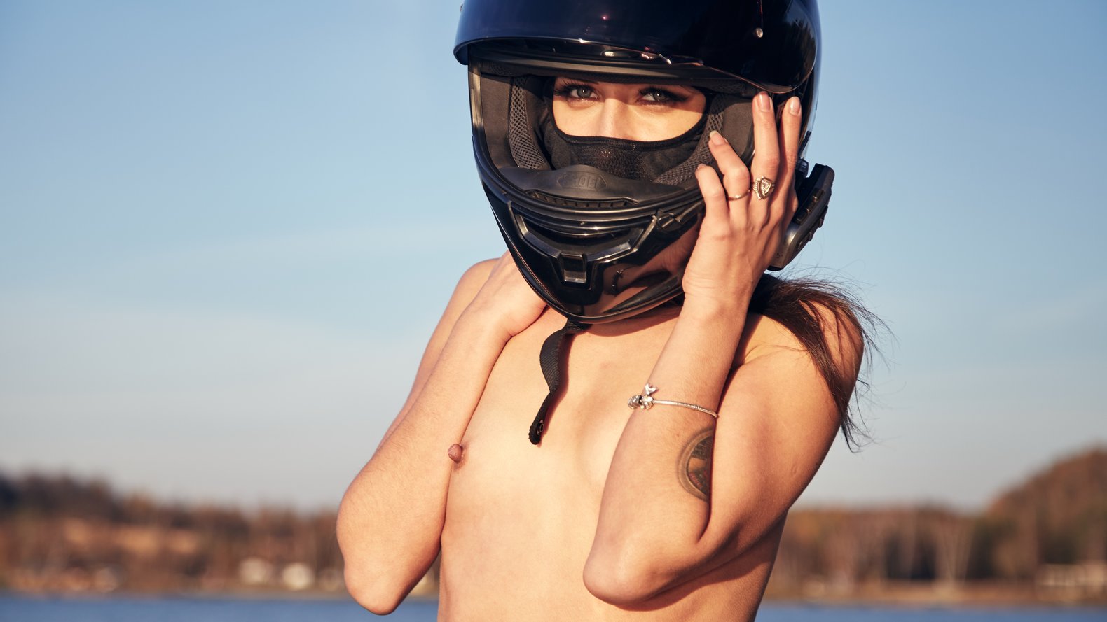 Topless flat chested girl in motorcycle helmet