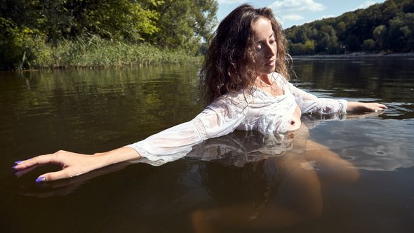 Nude female underwater legs and breasts