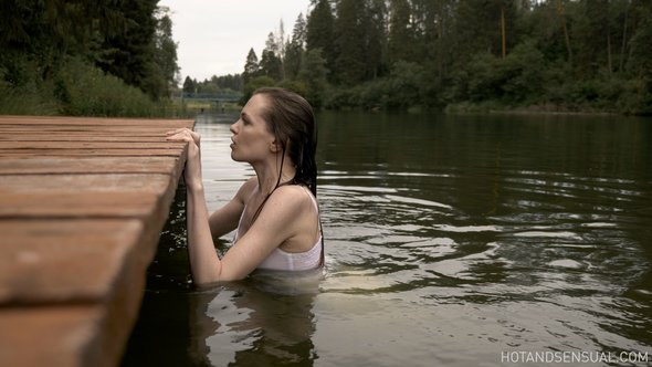 Nude woman at lake bating and relaxing