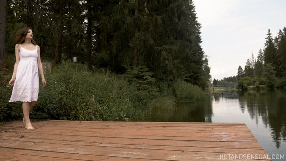 Nude woman at lake bating and relaxing