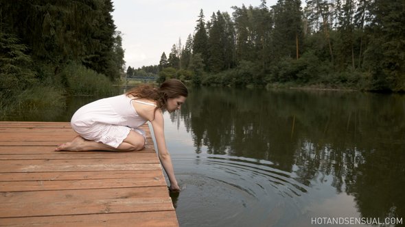 Nude woman at lake bating and relaxing