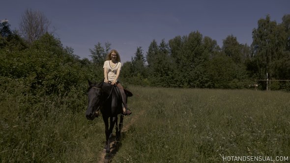 Sexy blonde with small tits bathing after riding a horse