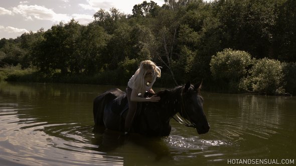 Sexy blonde with small tits bathing after riding a horse
