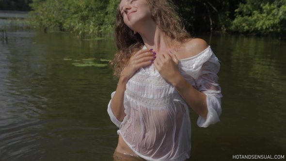 Sexy girl flirts bathing in wet see through blouse