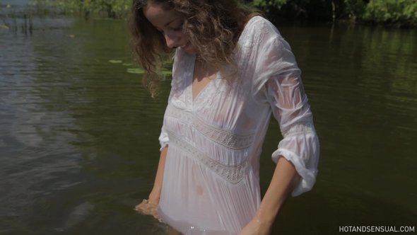 Sexy girl flirts bathing in wet see through blouse