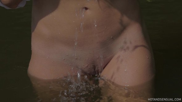 Sexy girl flirts bathing in wet see through blouse